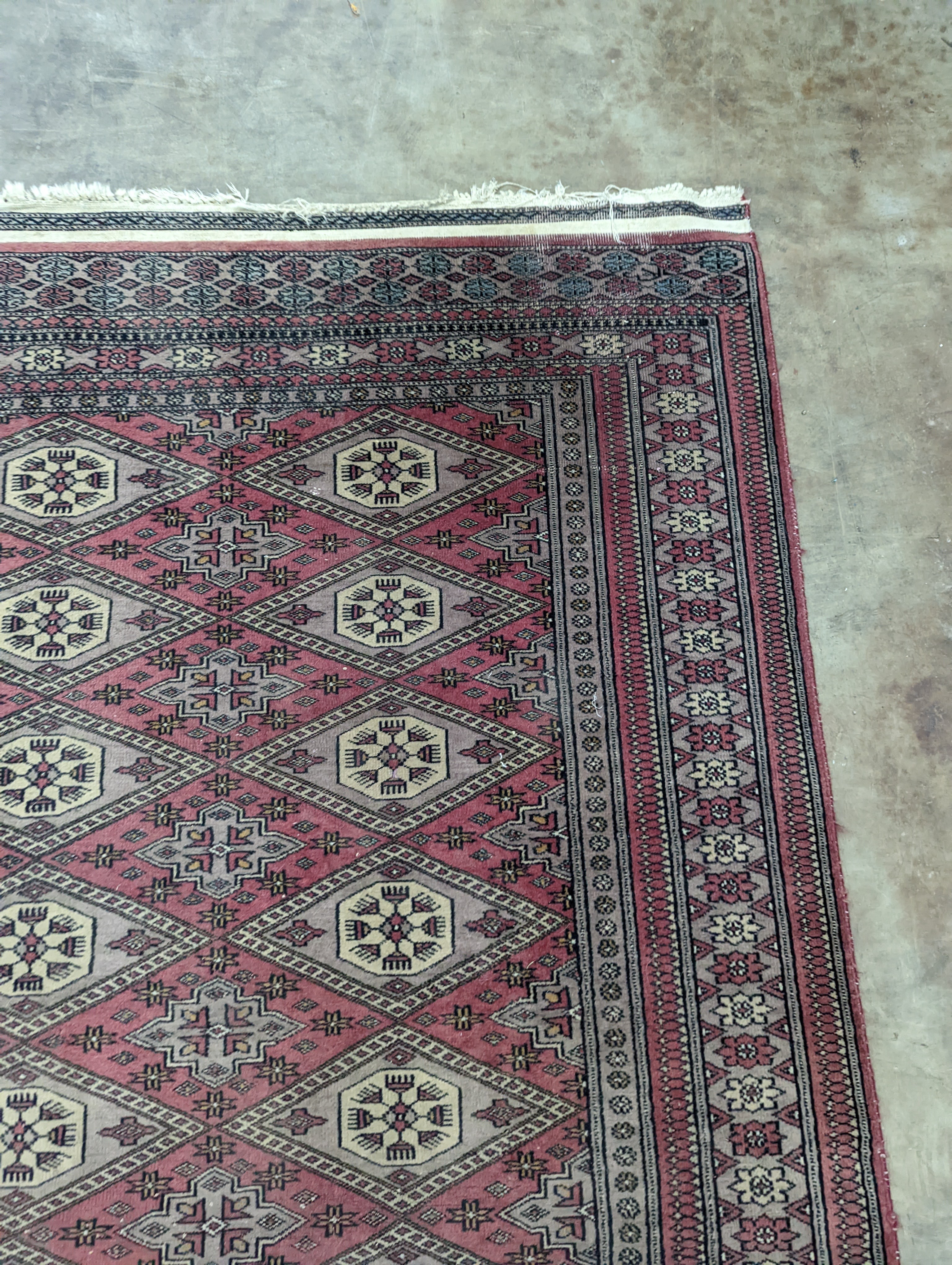 A Tekke Bokhara red ground rug, woven with rows of elephant feet, 180 x 126cm